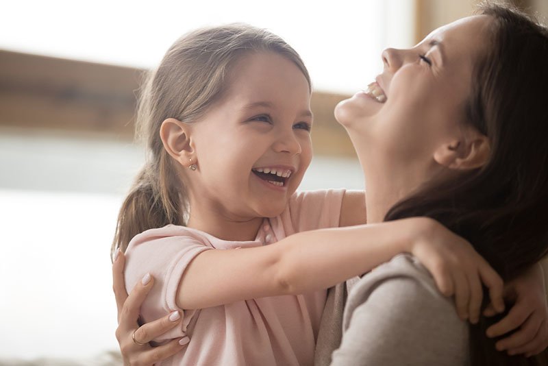 Mom and child laughing and at ease.