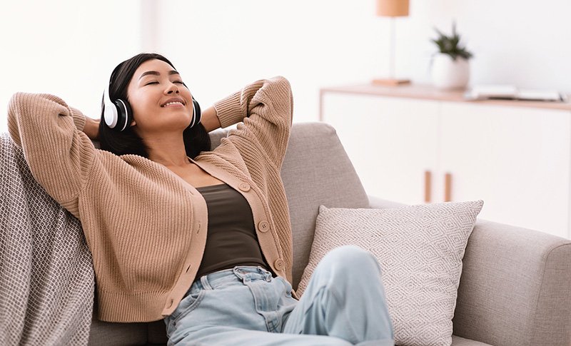 Relaxed Woman Listening to Music with Headphones.