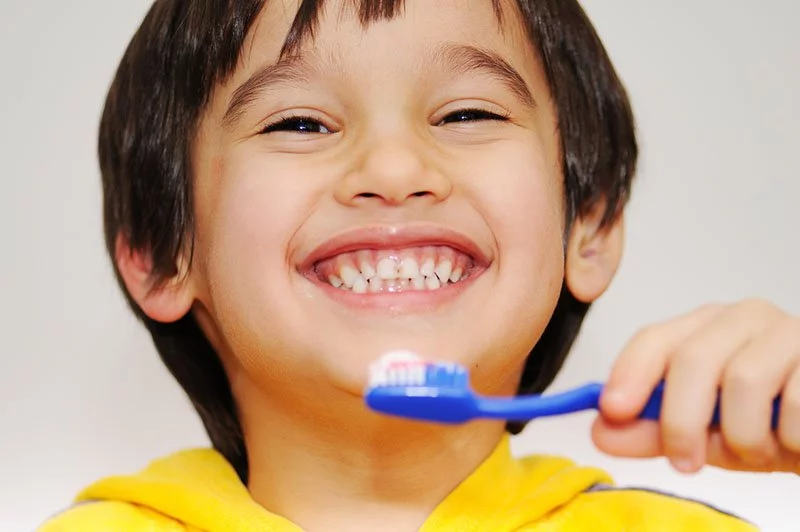 Kid brushing his teeth